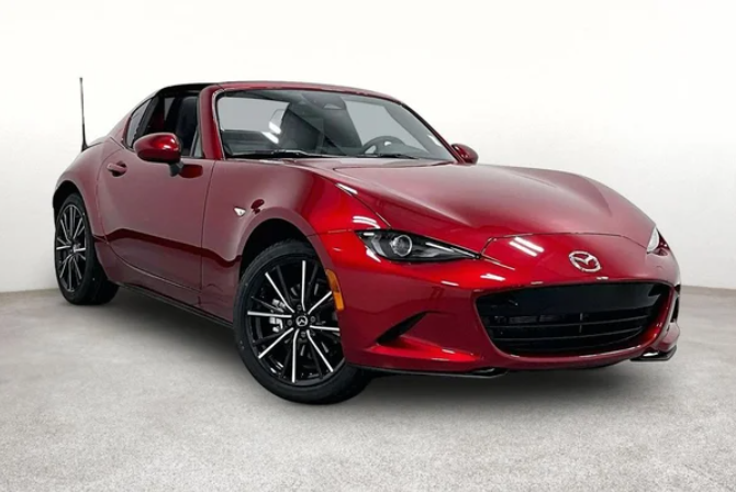 Mazda MX-5 Miata RF parked, showcasing its sleek design and sporty features in a vibrant outdoor setting.